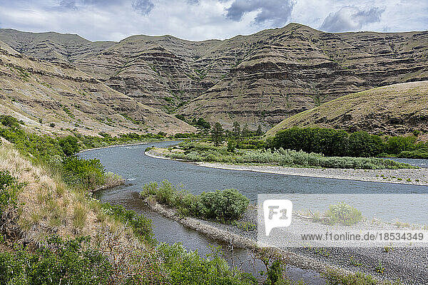 Gravel bars of the wild Snake River and the exposed geologic and eroding cliffs as seen from the Washington side looking across to the Idaho side; Asotin  Washington  United States of America