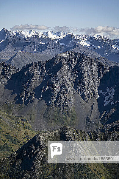 Luftaufnahme der majestätischen Berggipfel der Chugach Mountain Range mit dem schneebedeckten Bergrücken in der Ferne gegen einen blauen Himmel im Chugach State Park entlang des Williwaw Lakes Trail im Herbst; Anchorage  Alaska  Vereinigte Staaten von Amerika