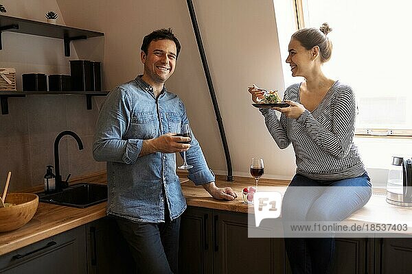 Side view of loving couple eating spaghetti while having romantic dinner together at home. Love  care  romance concept