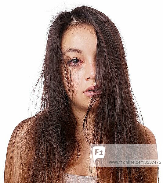 sad young asian woman with disheveled hair and red eyes from crying