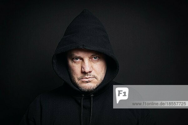 man wearing black hoodie hooligan or gangster concept
