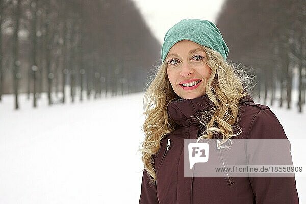 woman enjoying leisure walk along snow covered alley in winter