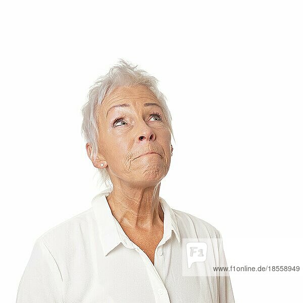 concerned senior woman looking up. isolated on white