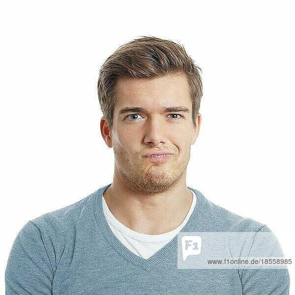 displeased or sceptical young man is making a face