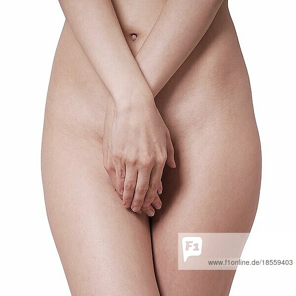 midsection of unrecognizable naked woman covering her private parts or genital area with hands  isolated on white