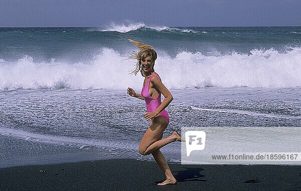Young woman in swimming costume on the beach Beach run  waves  sea