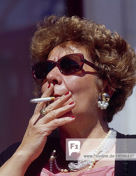 Elderly woman smoking cigarette