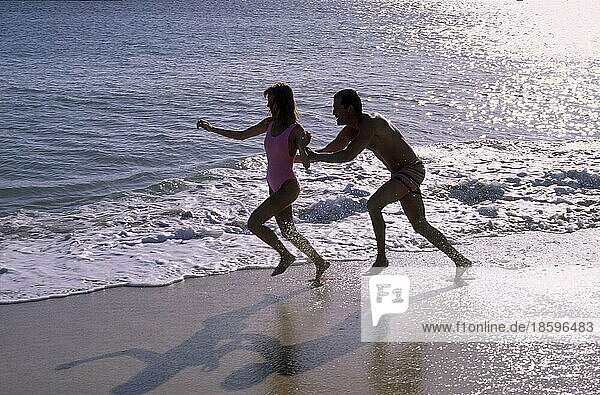 Young couple  beach running  waves  sea