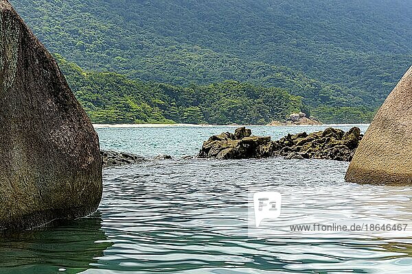 Beach and tropical forest in Trindade  Paraty seen through the rocks  Brasil