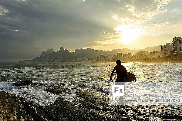Surfer at sunset in Arpoador beach at Ipanema in Rio de Janeiro  Praia do Arpoador  Rio de Janeiro  Rio de Janeiro  Brasil