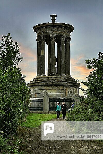 Walkers in front of Dugald Stewart Monument  Calton Hill  evening sky  Edinburgh  Scotland  United Kingdom  Europe