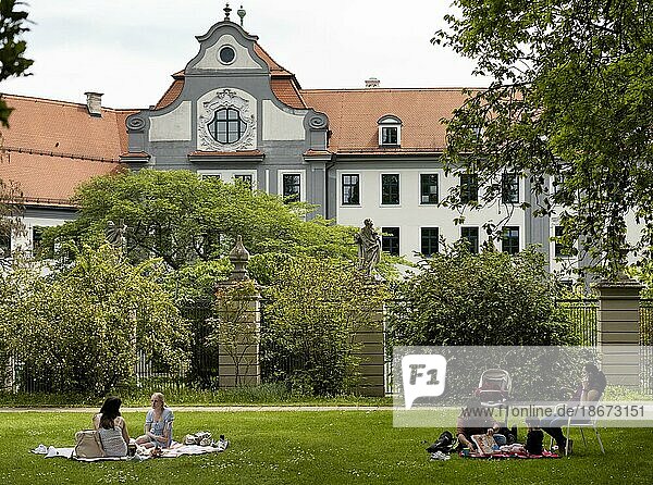People enjoying the warm weather and relaxing in the Hofgarten  Augsburg  Bavaria  Germany  Europe