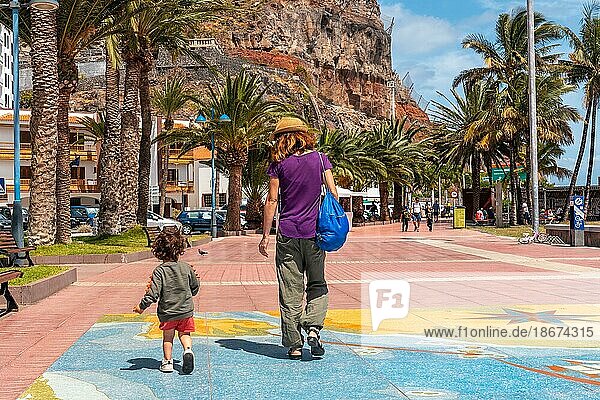 Walking along the promenade in the city of San Sebastian de la Gomera and its Iglesia De La Asuncion  Canary Islands
