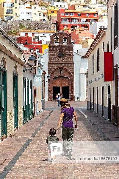 Vacation concept  mother with her son in the city of San Sebastian de la Gomera next to the Iglesia De La Asuncion  Canary Islands