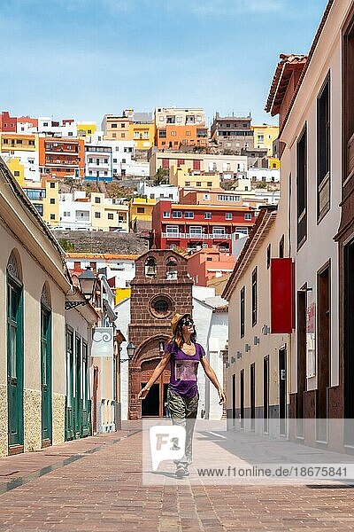 Vacation concept  woman enjoying in the city of San Sebastian de la Gomera next to the Iglesia De La Asuncion  Canary Islands