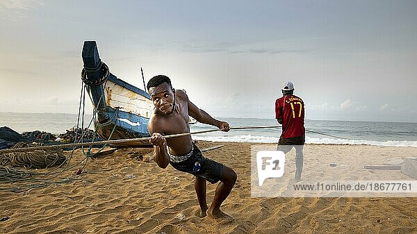 Young fisherman helps to land a catch  Togo  Lome.  Lome  Togo  Africa