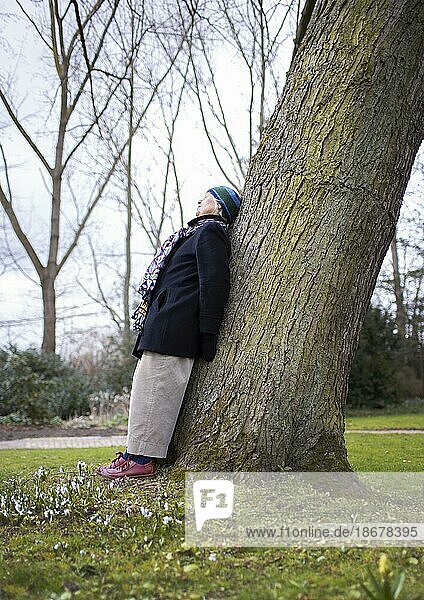 Subject: Pensioner leaning against a tree  Dortmund  Germany  Europe