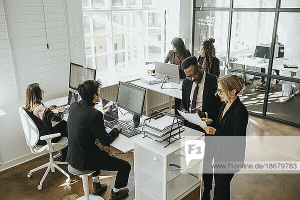 High angle view of corporate colleagues working together at office