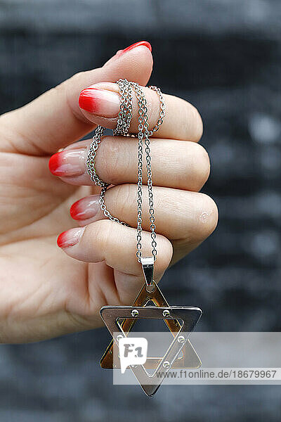 Close up on hands of woman with a Star of David (Jewish Star) pendant  Vietnam  Indochina  Southeast Asia  Asia