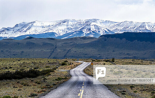 Highway leading to snow covered mountains  Torres del Paine National Park  Chile  South America