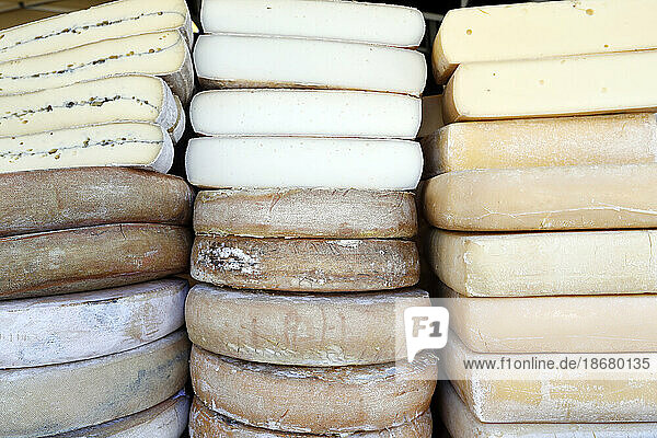 Traditional French cheese  Raclette and Morbier  mountain cheese for sale at market  France  Europe