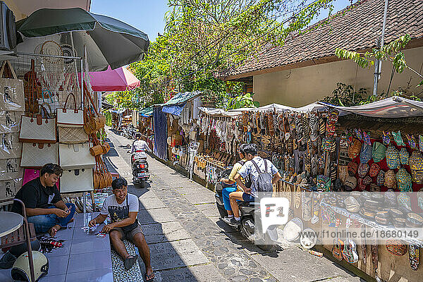 Motorcycles and souvenir stalls on street in Ubud  Ubud  Kabupaten Gianyar  Bali  Indonesia  South East Asia  Asia