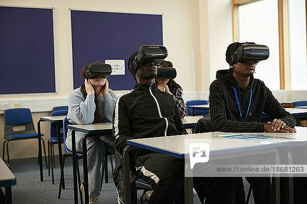 Students (16-17) wearing VR headsets in class