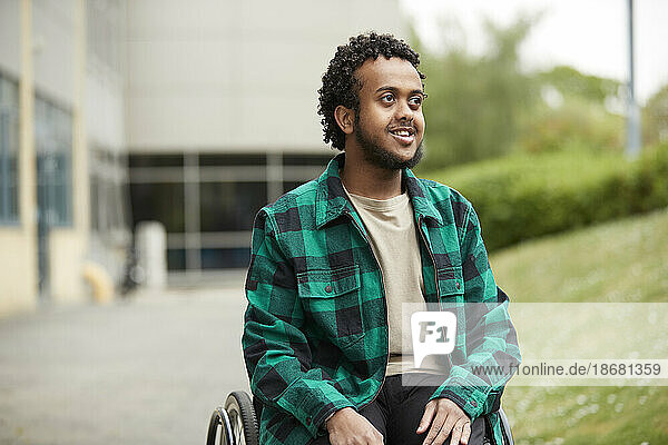 Smiling young man in wheelchair