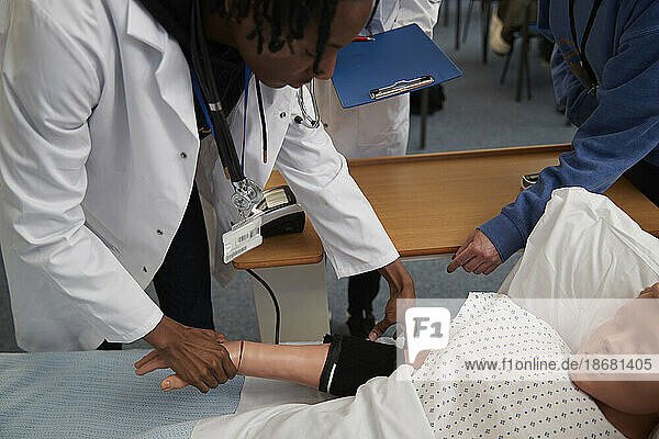 Medical student learning how to measure blood pressure