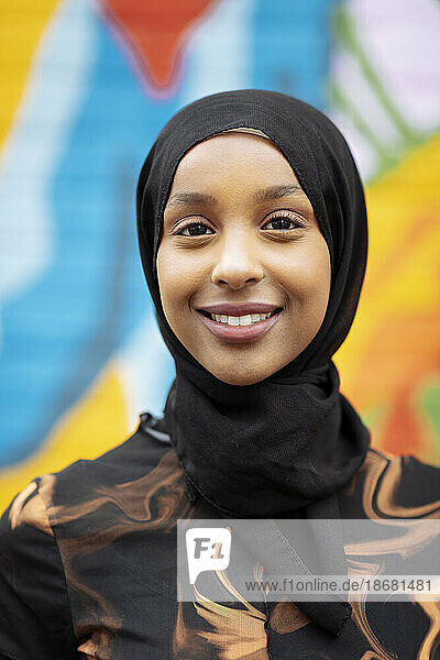 Portrait of smiling young woman wearing hijab