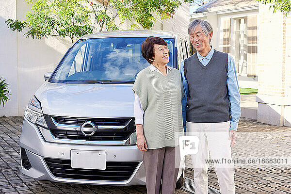 Japanese senior couple with car