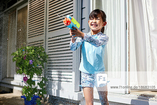 Japanese kid playing with water gun