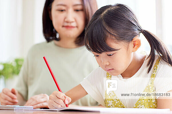 Japanese kid studying with her mother