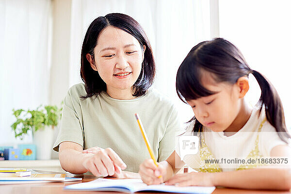 Japanese kid studying with her mother