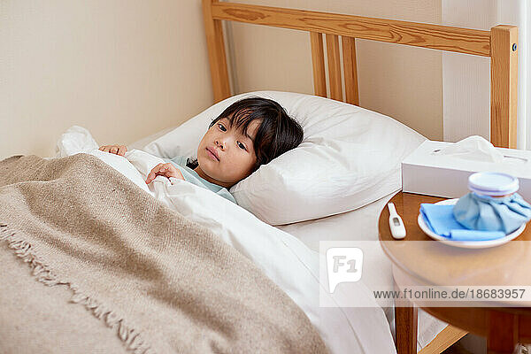 Japanese kid sick in bed