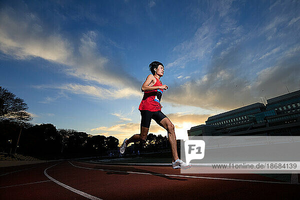 Japanese athletes running on track