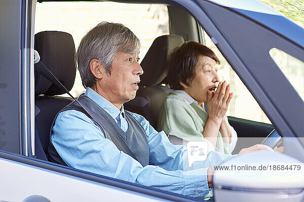 Japanese senior couple with car