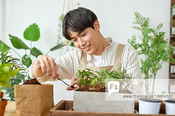Young Japanese man gardening
