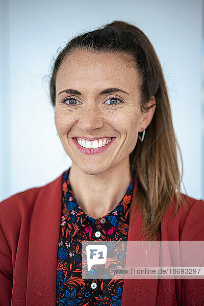 Happy businesswoman wearing patterned shirt and blazer