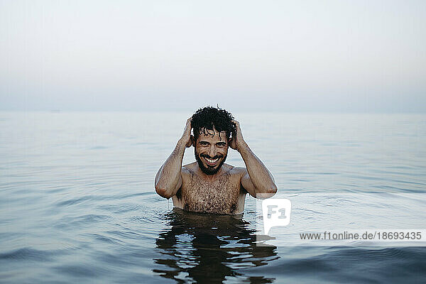 Shirtless happy man enjoying in sea