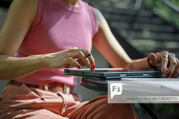 Woman using graphics tablet at table