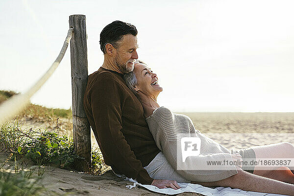 Happy mature woman enjoying with man at beach