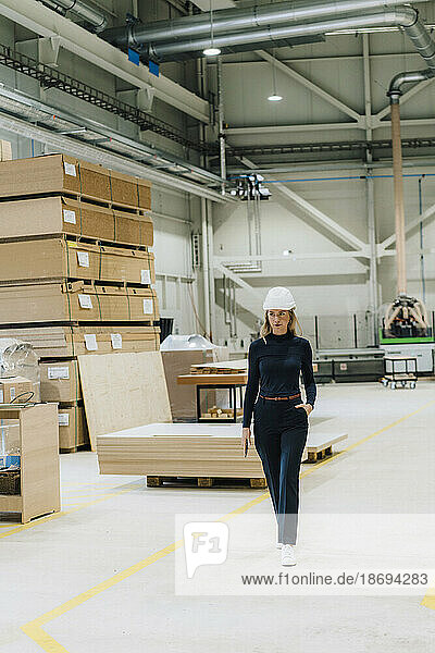 Businesswoman walking in carpentry factory