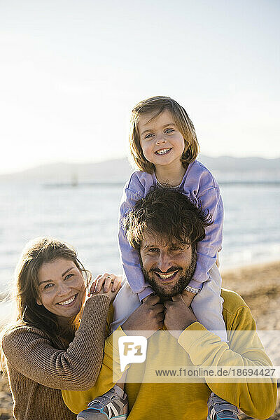 Happy family enjoying vacations at beach