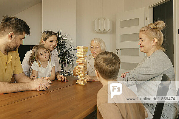 Multi-generation family spending leisure time playing game at home