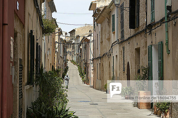Alley amidst old buildings of Alcudia  Mallorca  Spain