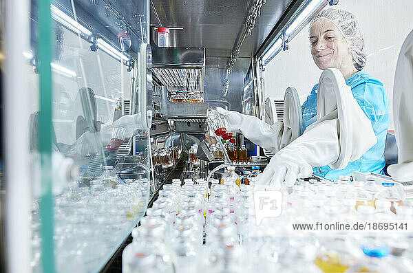 Scientist working in microbiological safety cabinet laboratory