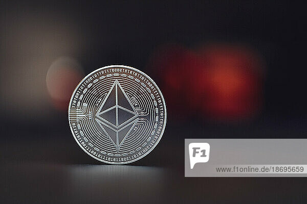 Close-up of silver colored Ethereum coin