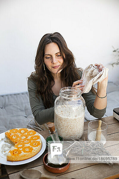 Woman taking fermented bulgur to elaborate vegan cheese