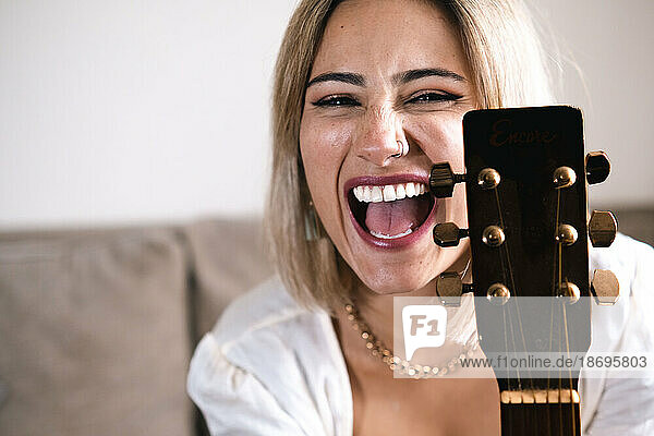 Cheerful blond musician with guitar